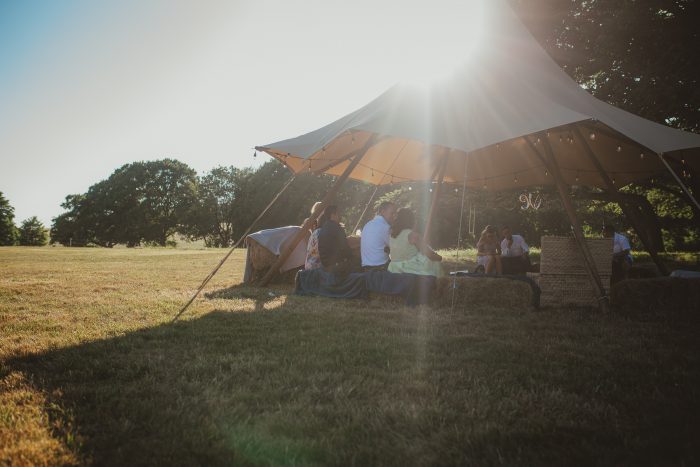 guests at festival canopy at boho wedding