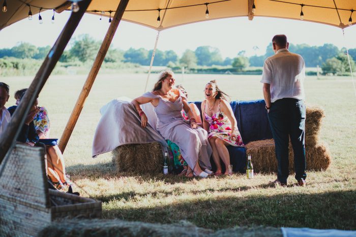 guests at festival canopy at boho wedding