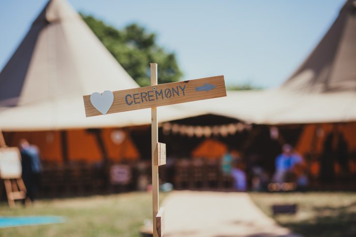 ceremony sign at tipi, festival wedding