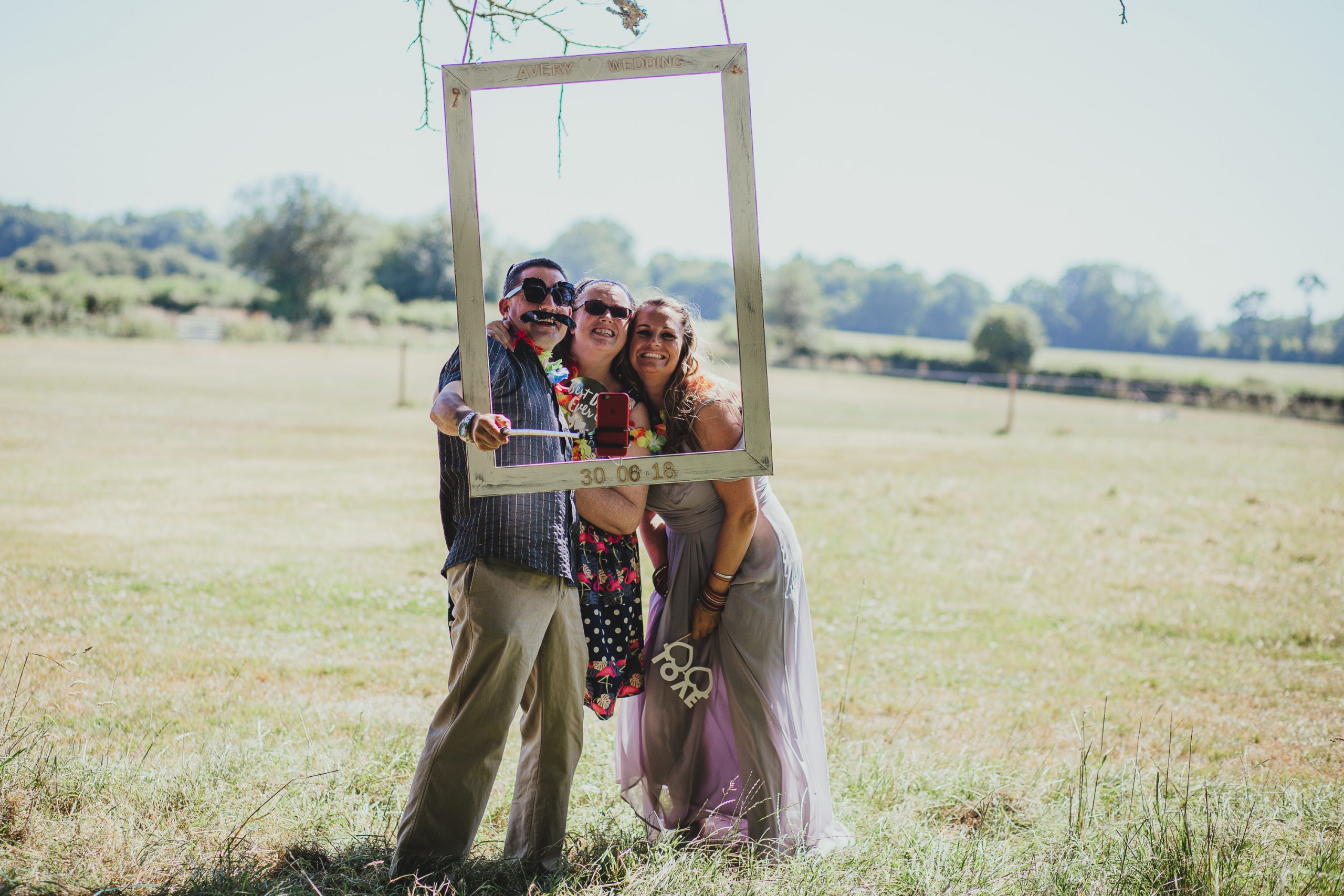 guests at outdoor photo booth at festival, boho wedding