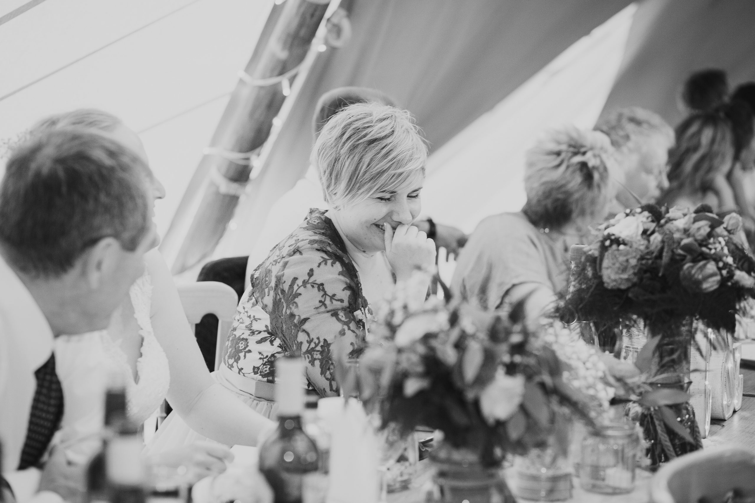 bride laughing in tipi at festival wedding