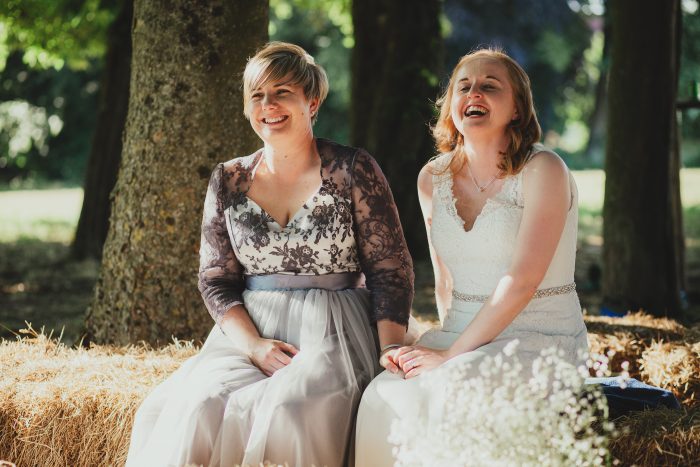 bride and bride at outdoor, boho wedding on haystack