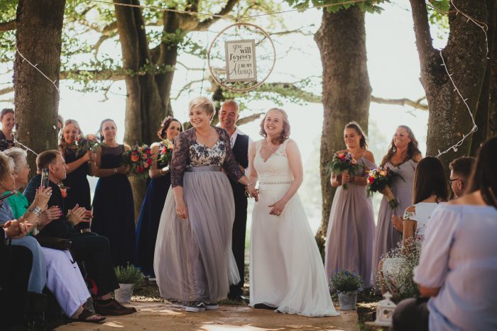 bride and bride at boho ceremony in woodland