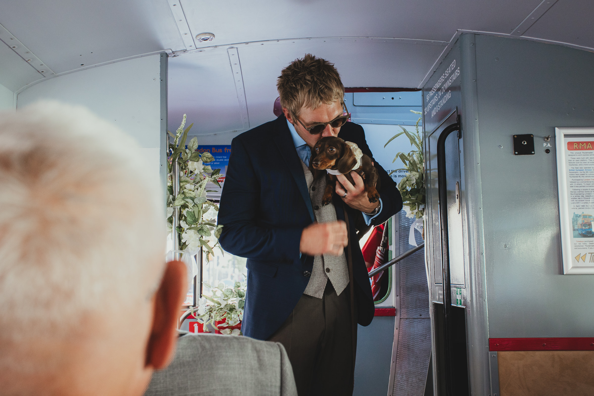 Groom on route mast bus with dog, travelling from Old Marylebone Town Hall