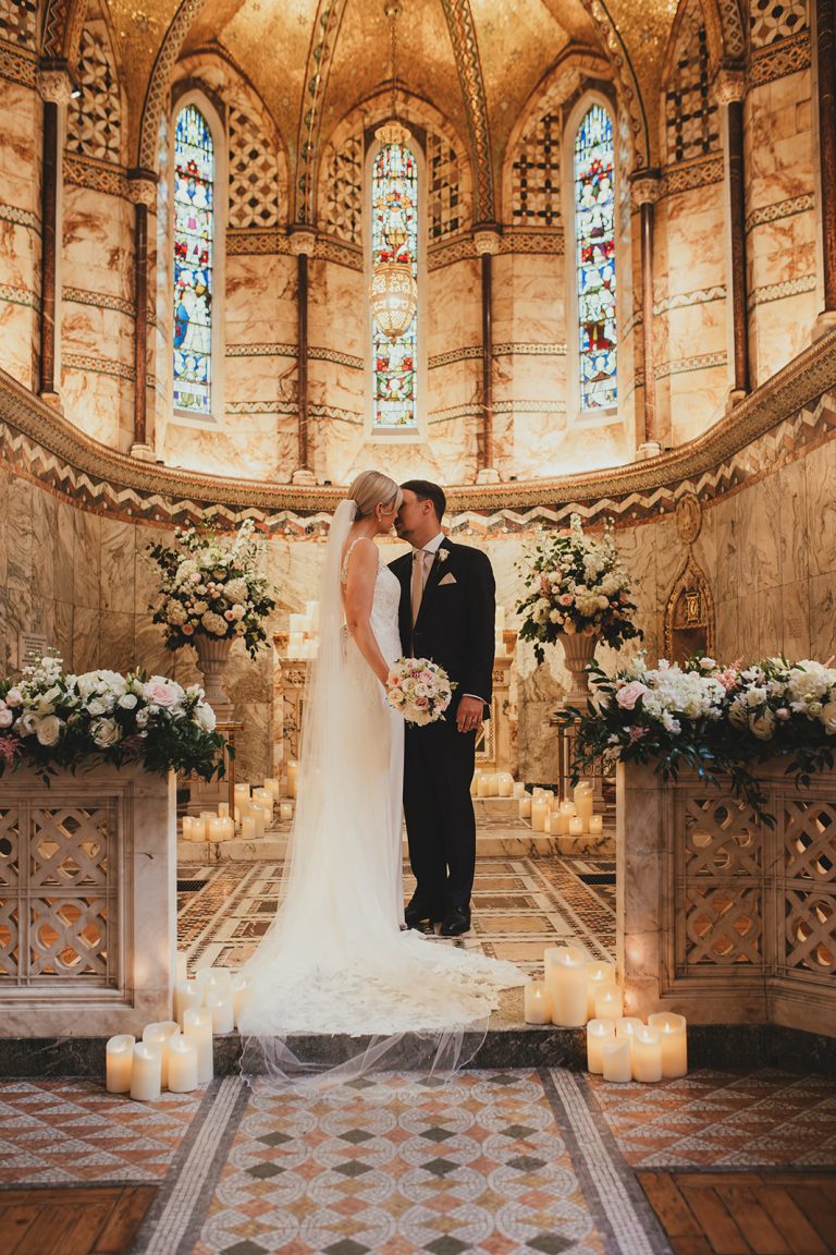 Bride and groom kissing at the alter in the Fitzrovia Chapel
