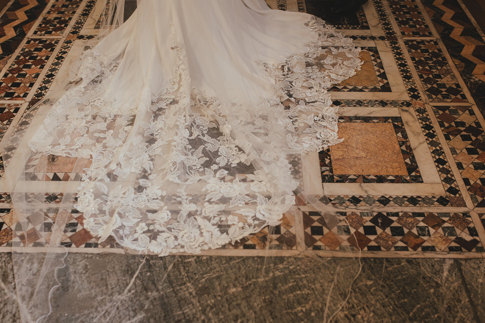 Lace detail shot of the bride's dress on the tiles of The Fitzrovia Chapel