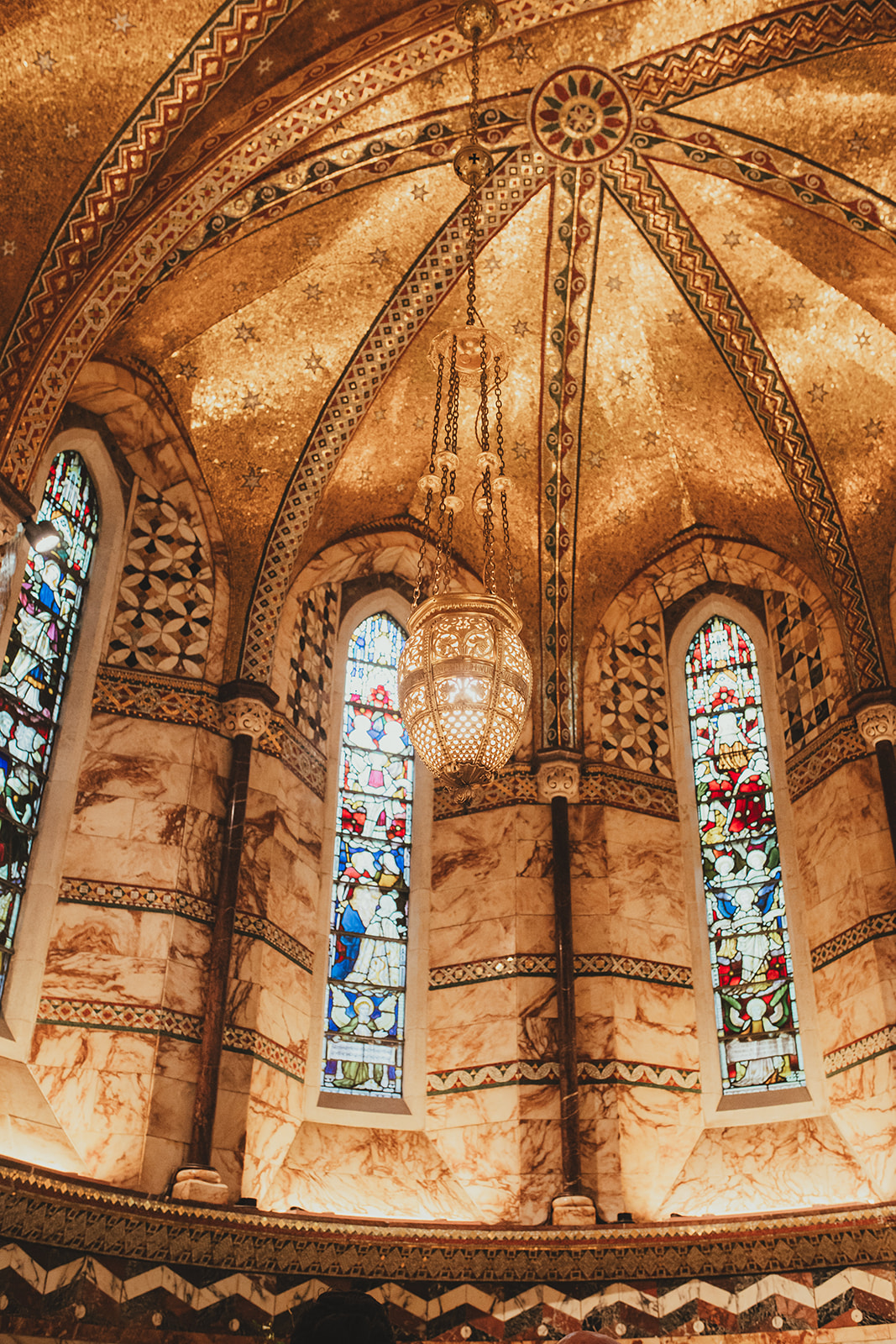 The golden tiles and stain galss windows of the Fitzrovia Chapel