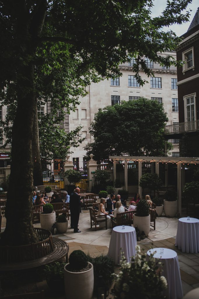 Guests mingling in the courtyard at The Langham London