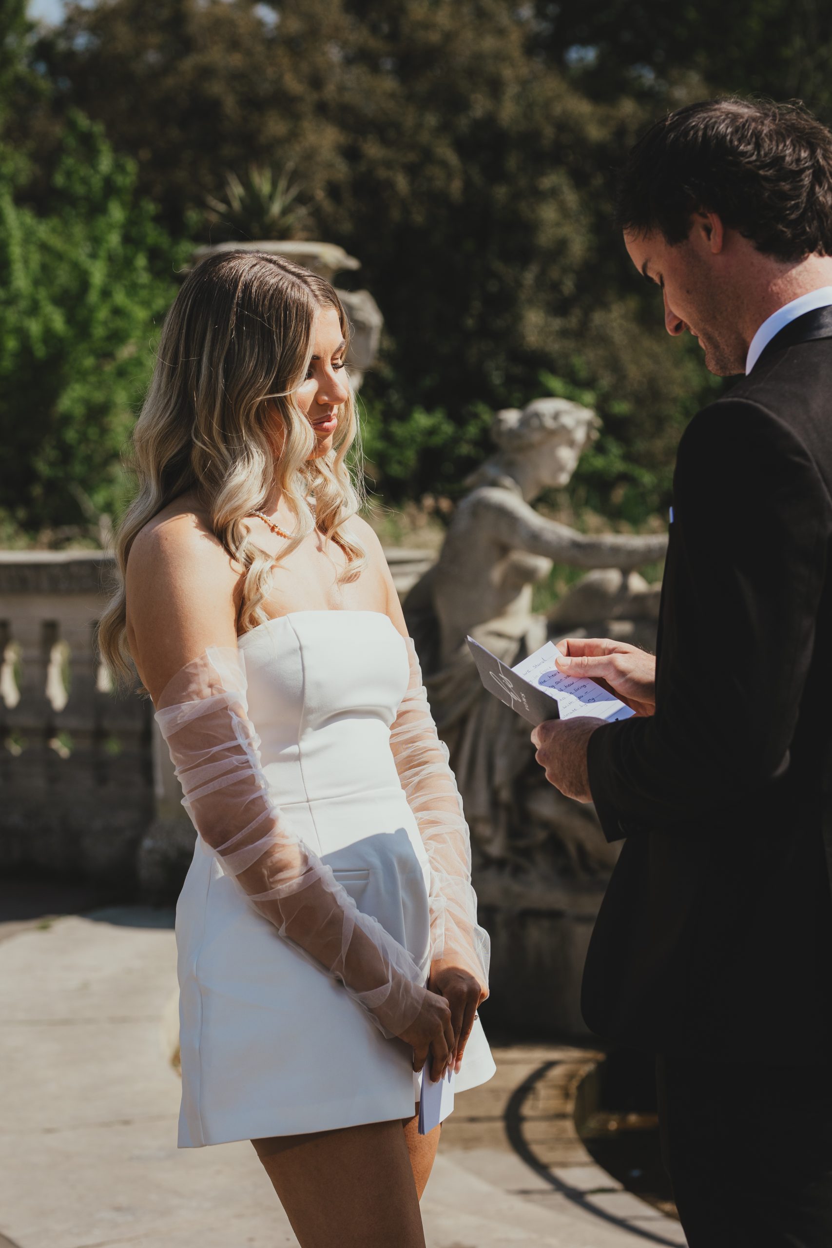 Bride listening to groom's vows in the Italian Gardens, London