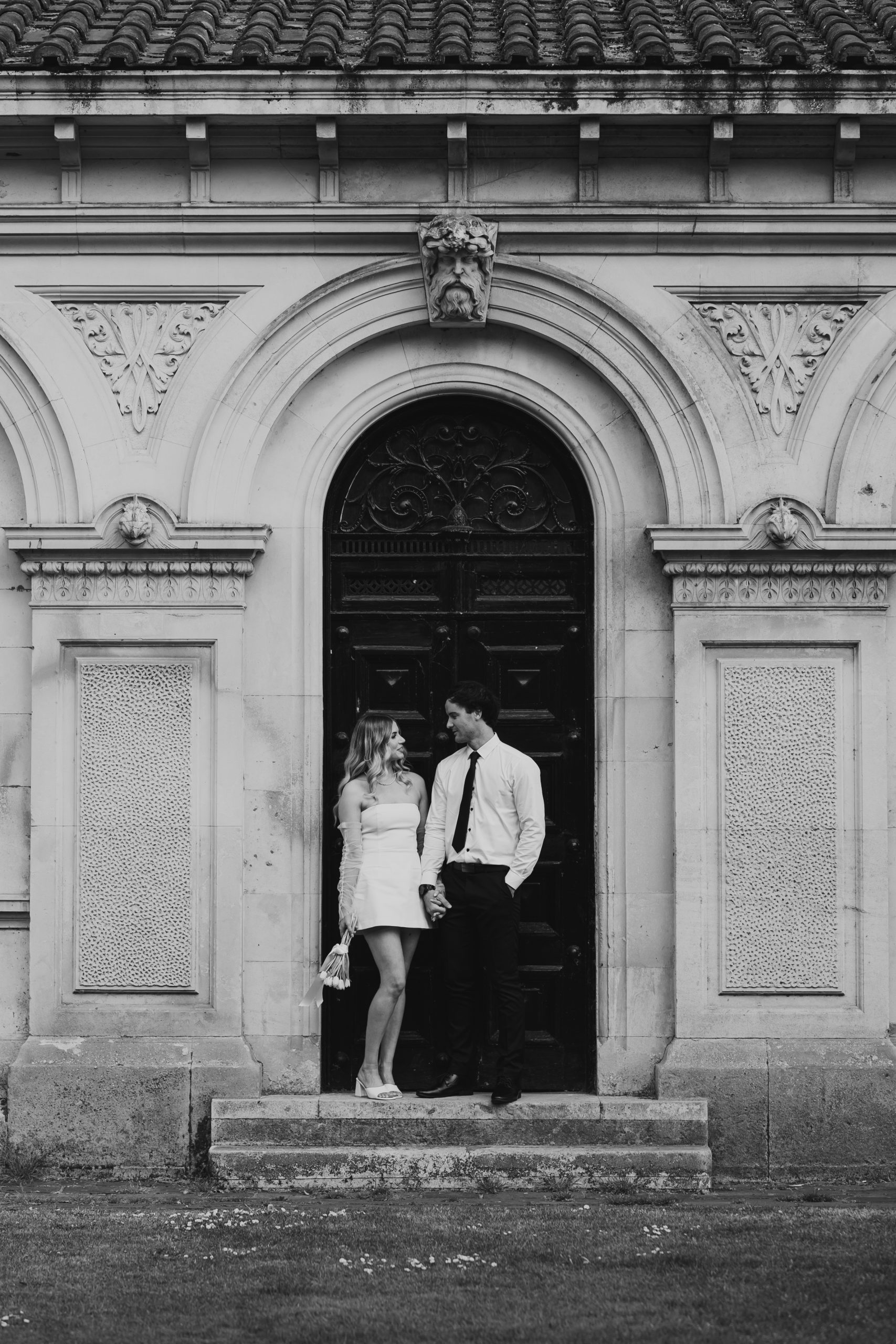 Couple framed by London architecture, elegant elopement portrait