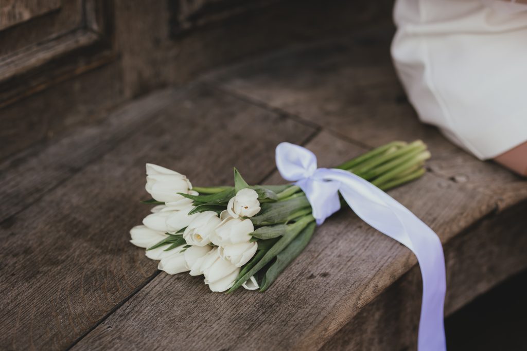 Close up of wedding flowers resting on a London bench