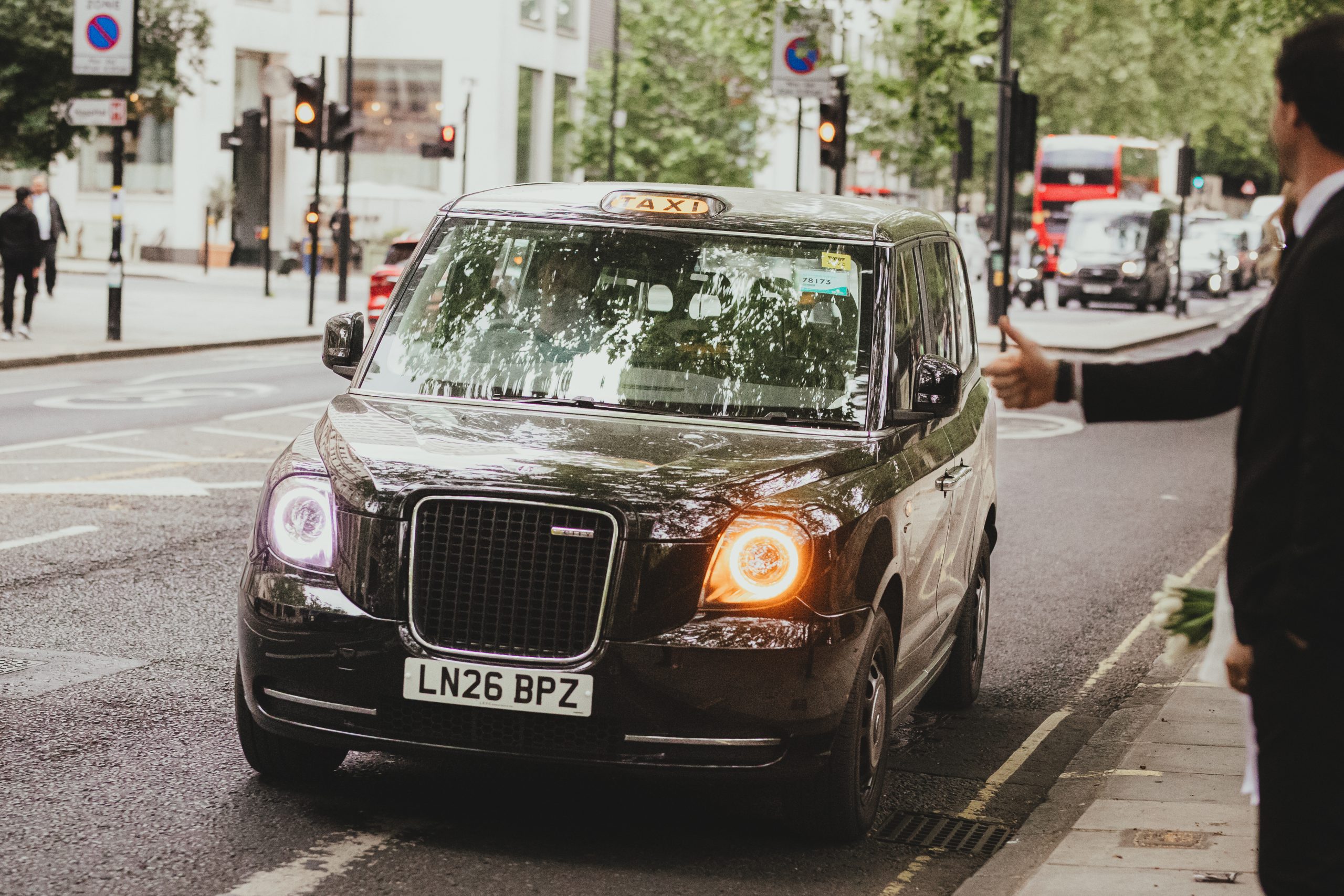 Bride and groom with a black cab in London