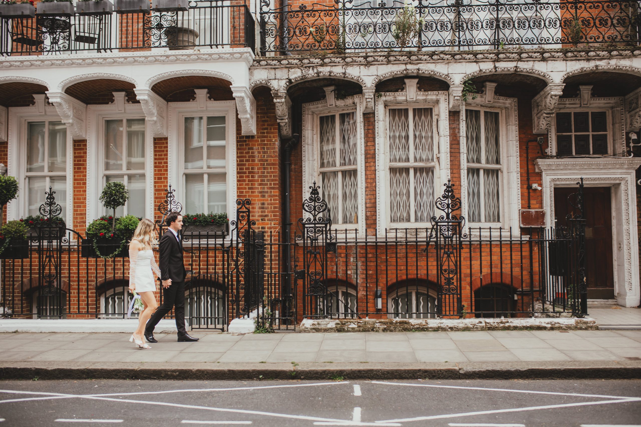 Bride and groom walking in London, documentary-style elopement photo
