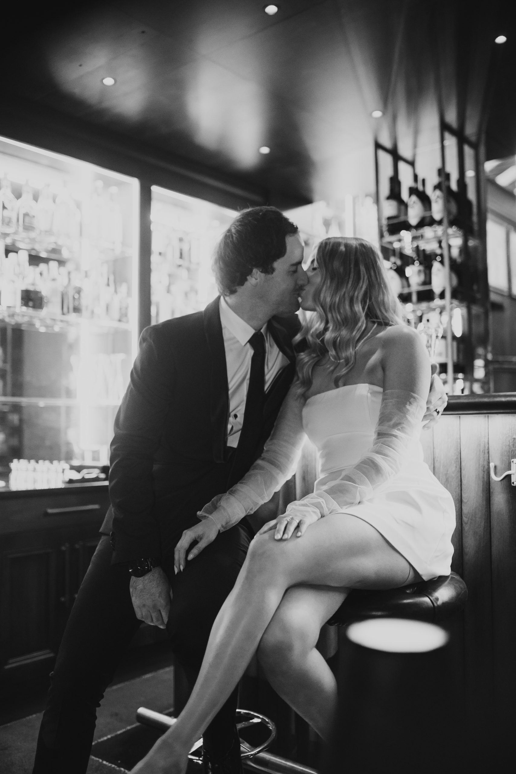 Back and white photo of bride and groom at the bar, warm and romantic London celebration