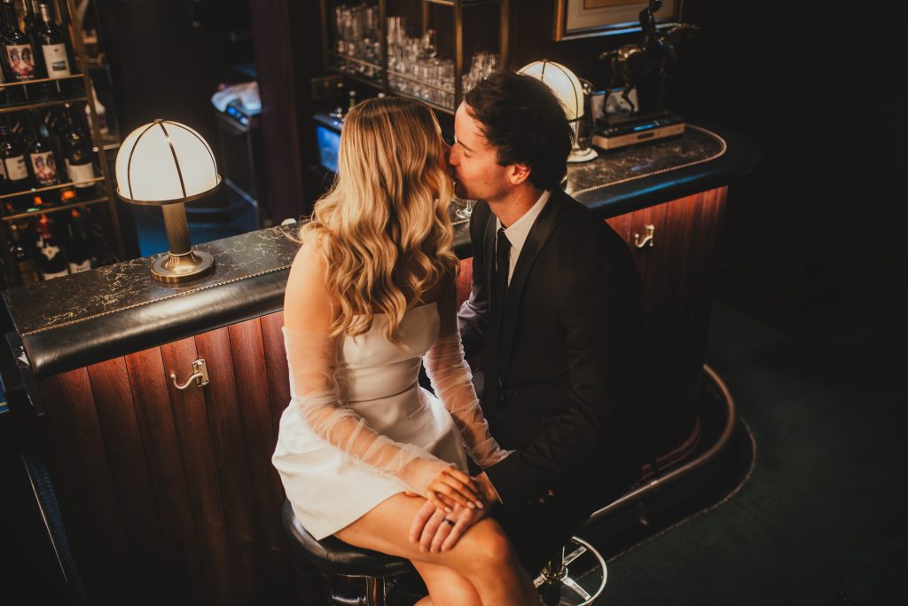 ride sitting for a portrait in a London bar, editorial wedding style