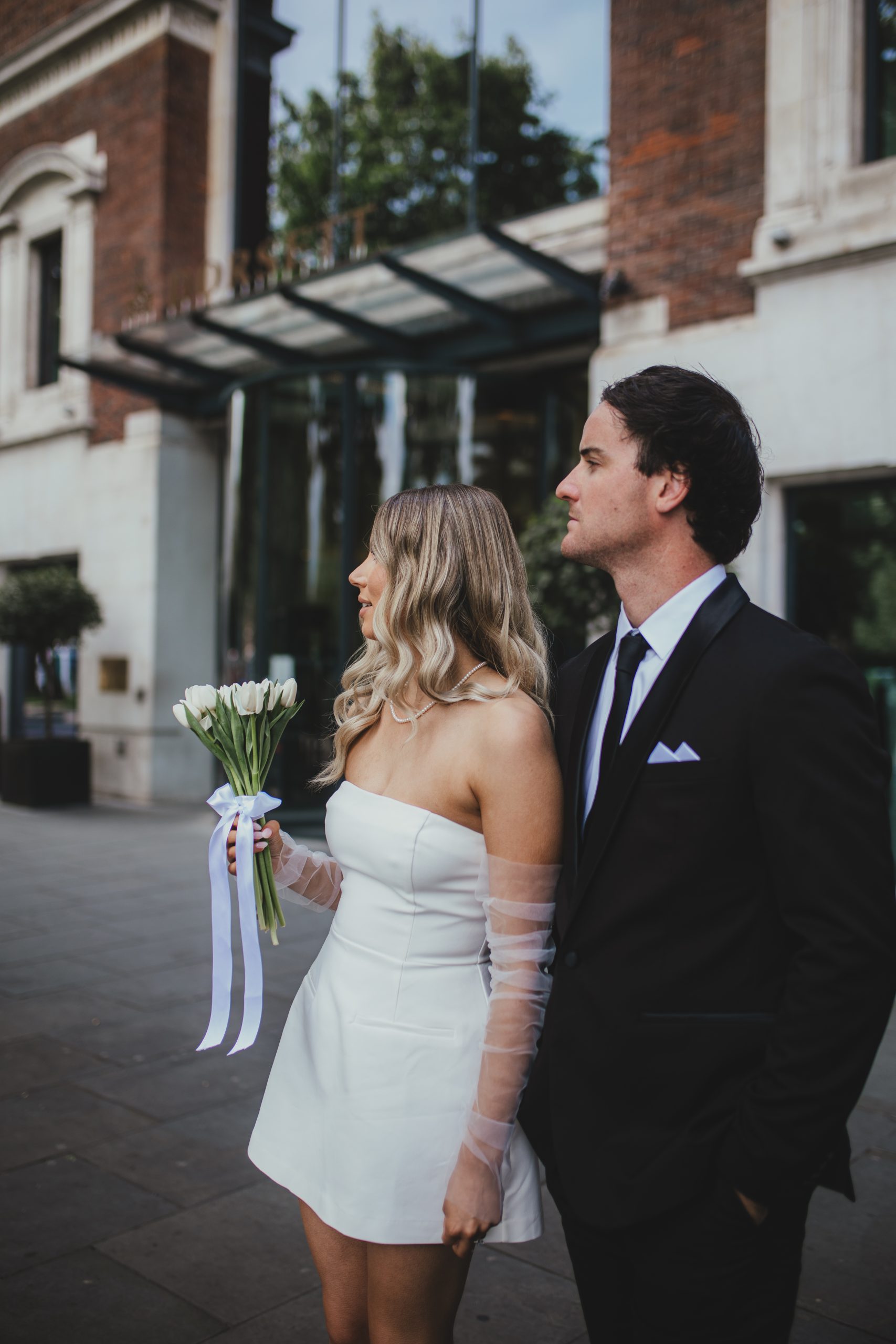 Bride and groom standing together outdoors hotel, London elopement portrait
