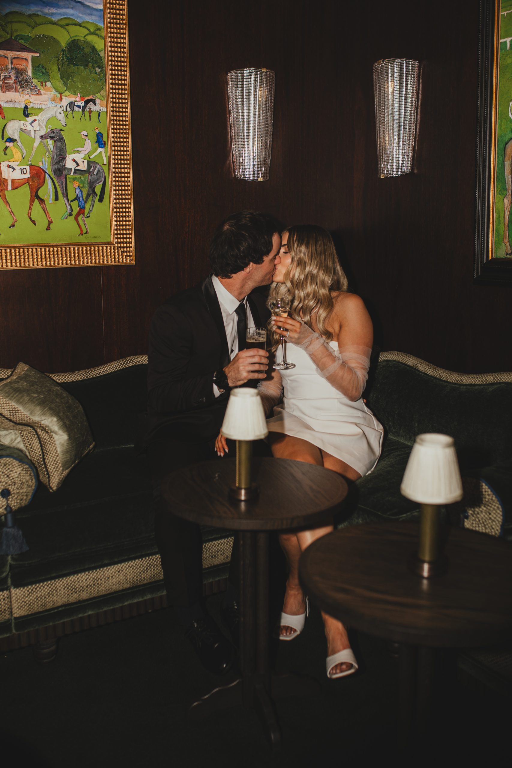 Couple seated with cocktails, intimate date-night wedding finish