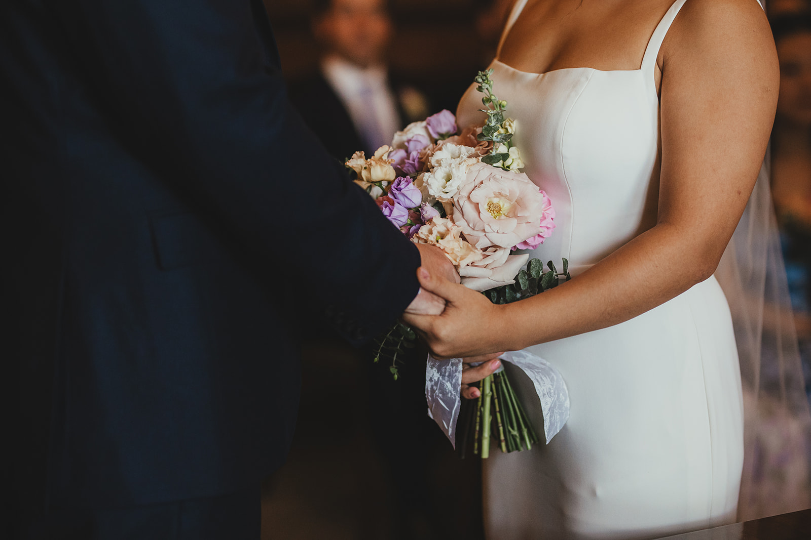 Bride and Groom holding hands during ceremony in the Westminster Room at Old Marylebone Town Hall, London