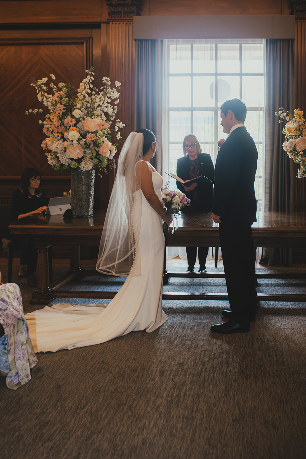 Bride and Groom in front of window during ceremony in the Westminster Room