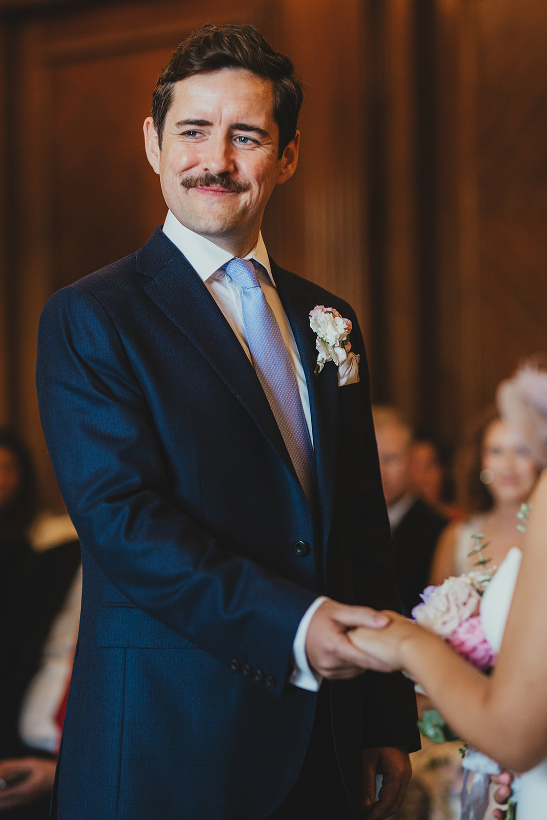 Groom smiling during vows in the Westminster Room