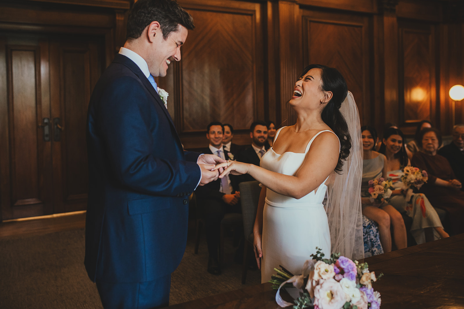 Bride laughing during the ceremony at Old Marylebone Town Hall