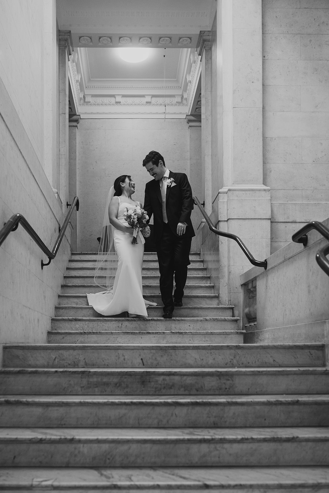 Bride and groom walking down the steps after the ceremony, Old Marylebone Town Hall