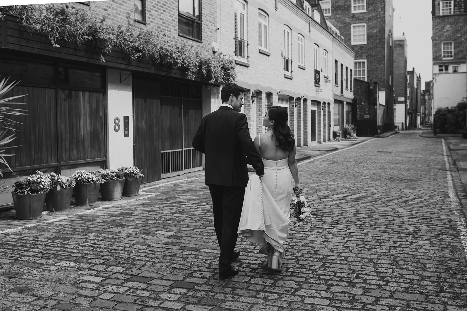Couple walking behind Old Marylebone Town Hall, London