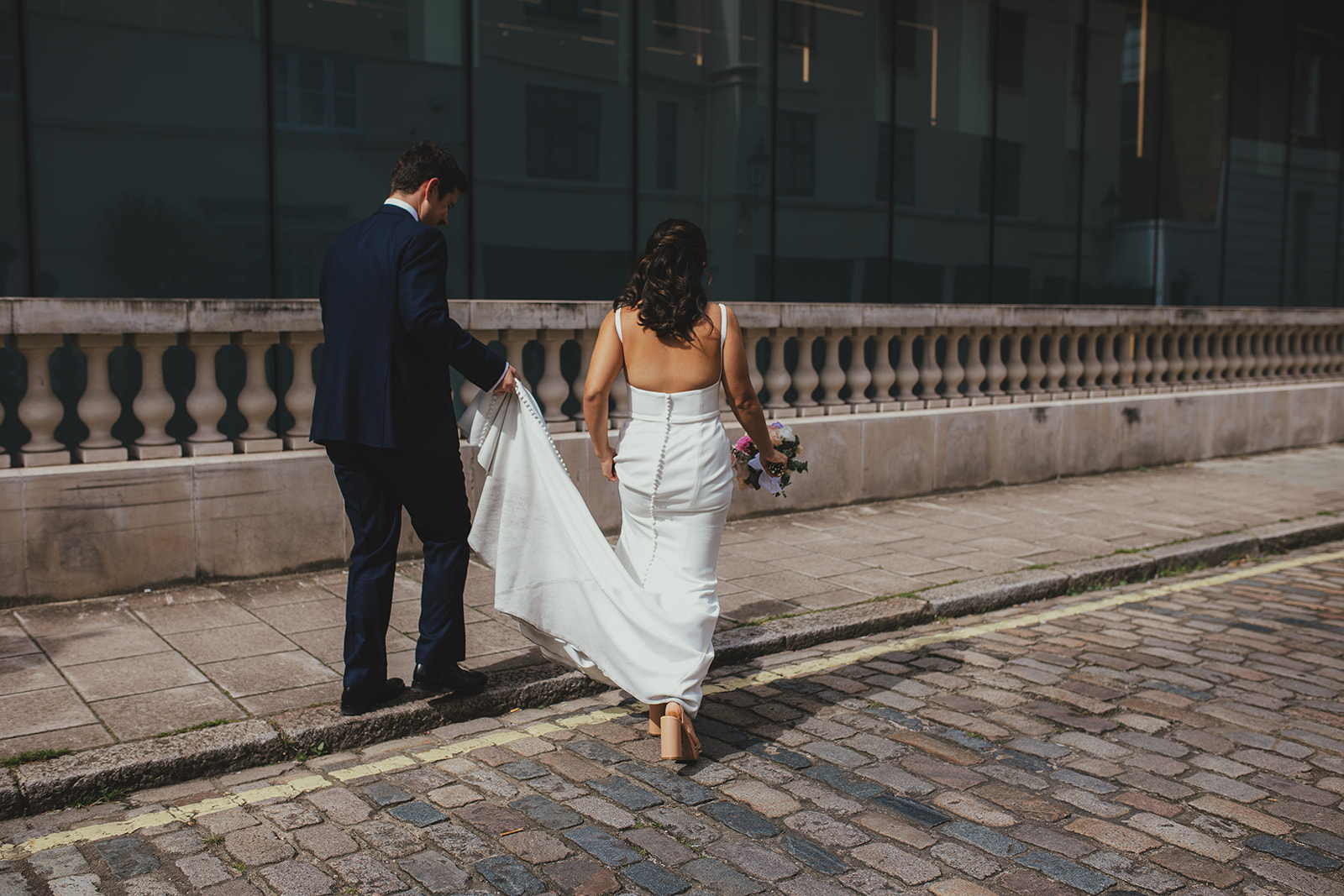 Couple walking behind Old Marylebone Town Hall, London