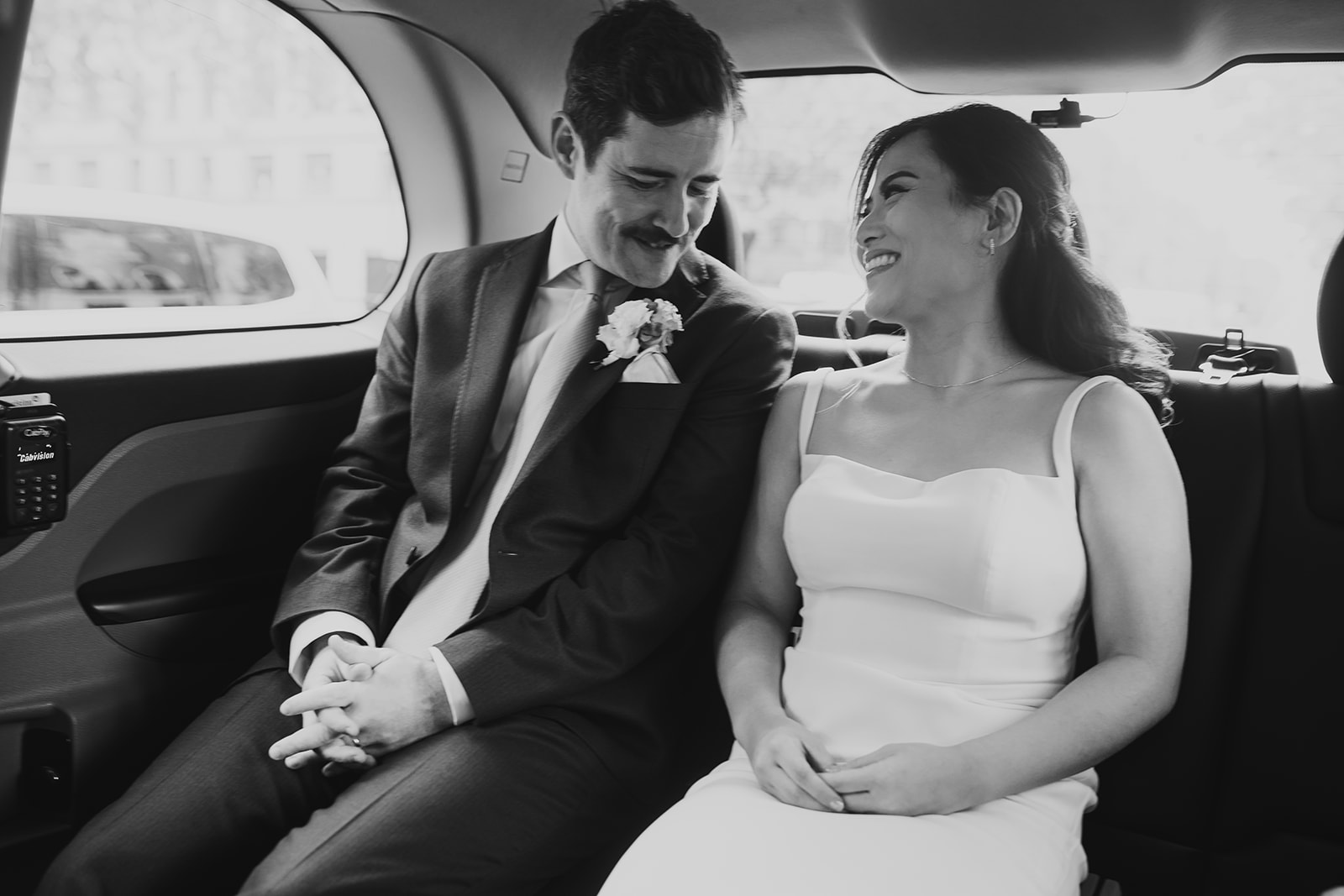 Bride and Groom in taxi after ceremony at Old Marylebone Town Hall, London