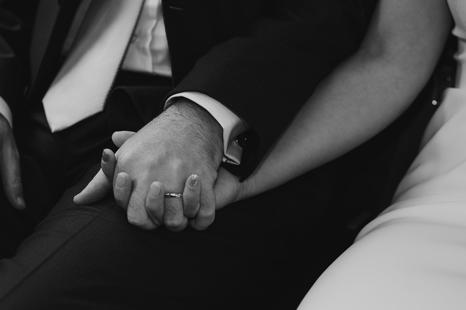Close up of Bride and Groom holding hands