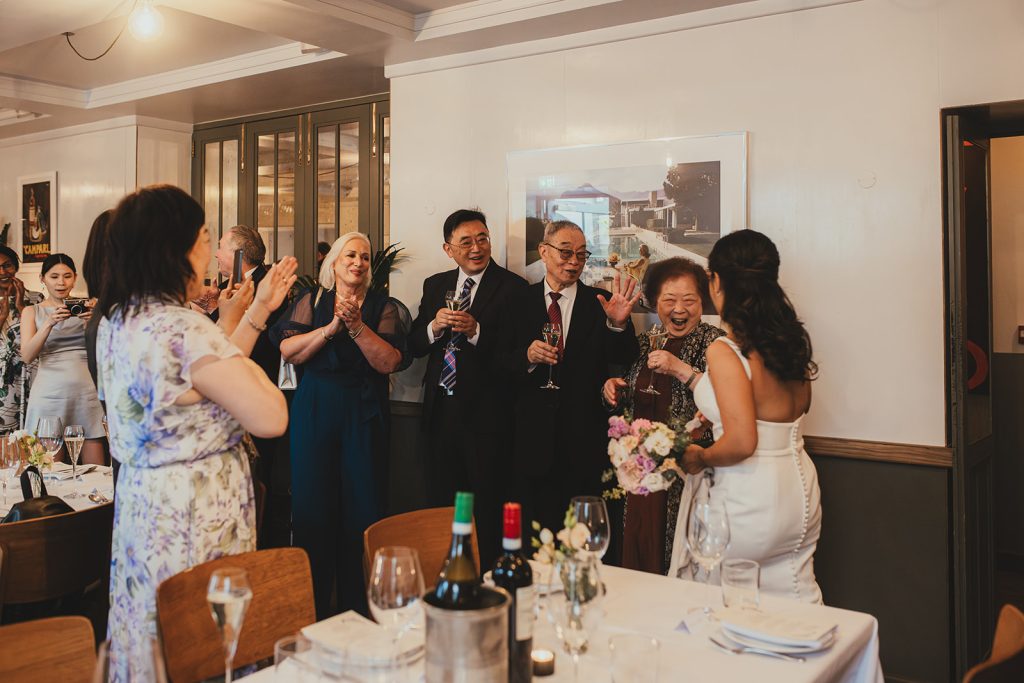 Couple celebrating with drinks at The Italian Greyhound, London