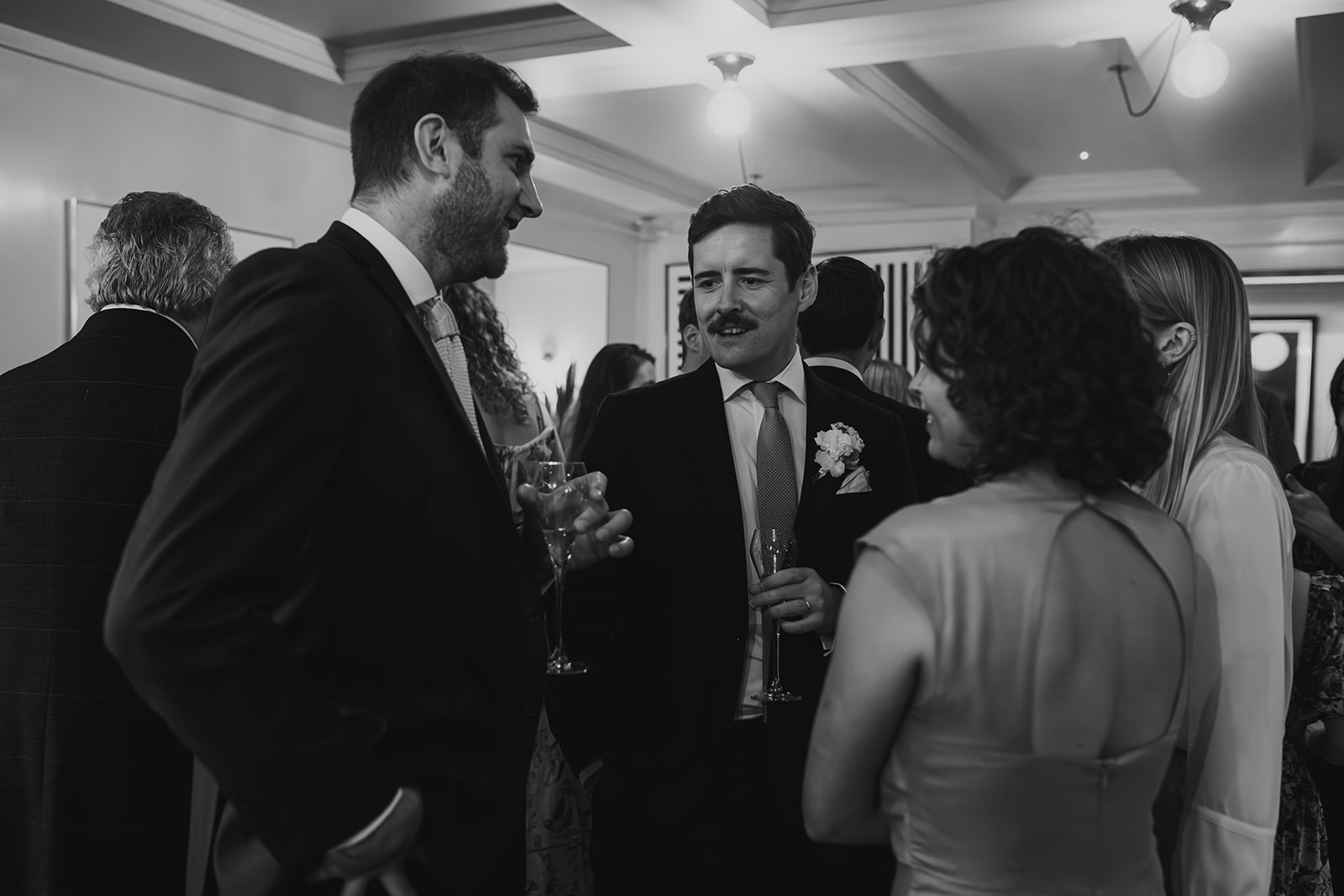 Couple celebrating with drinks at The Italian Greyhound, London