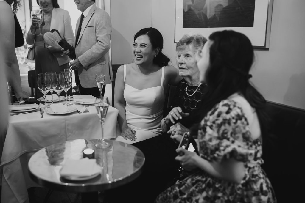 Couple celebrating with drinks at The Italian Greyhound, London