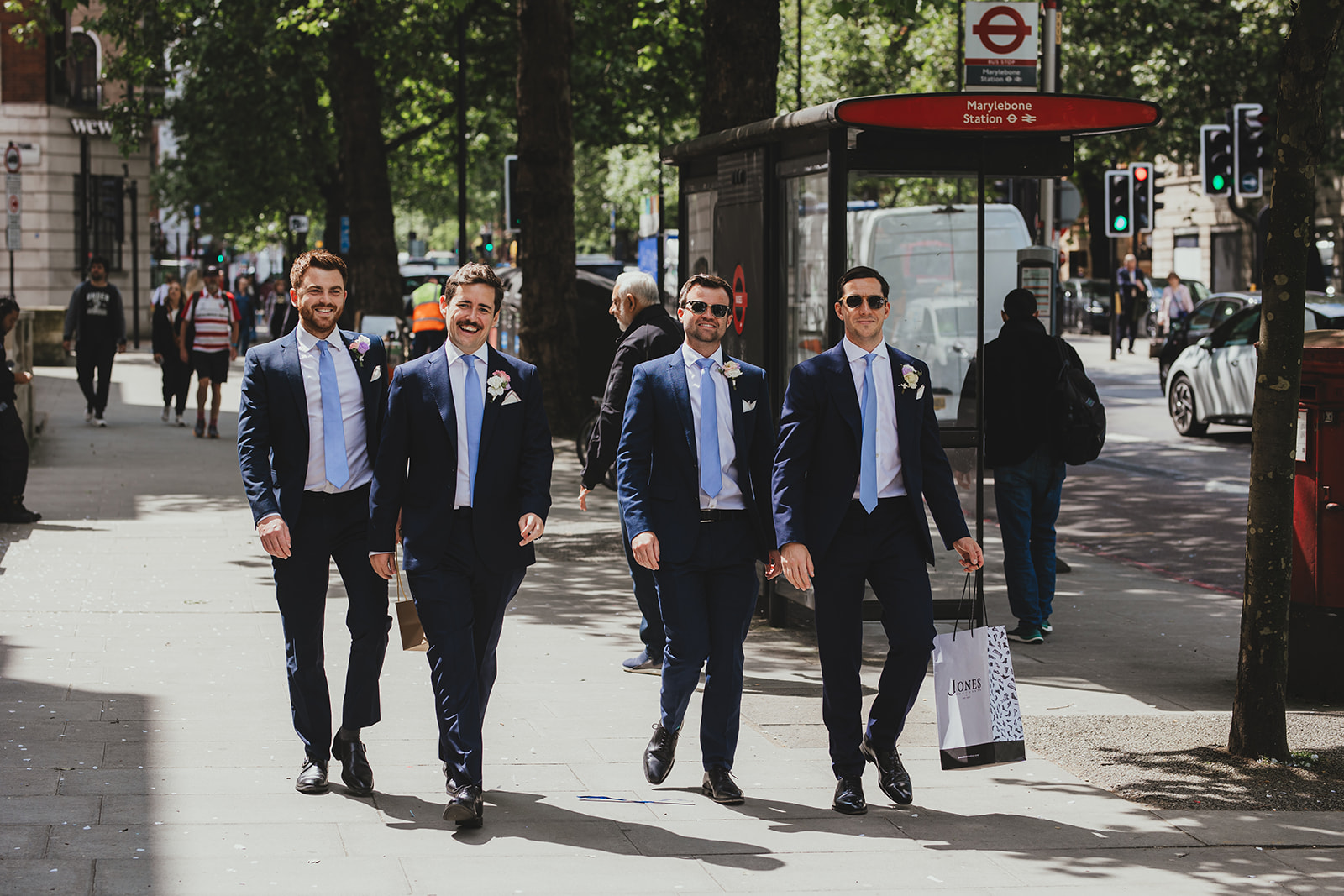 Groomsmen walking outside Old Marylebone Town Hall, London