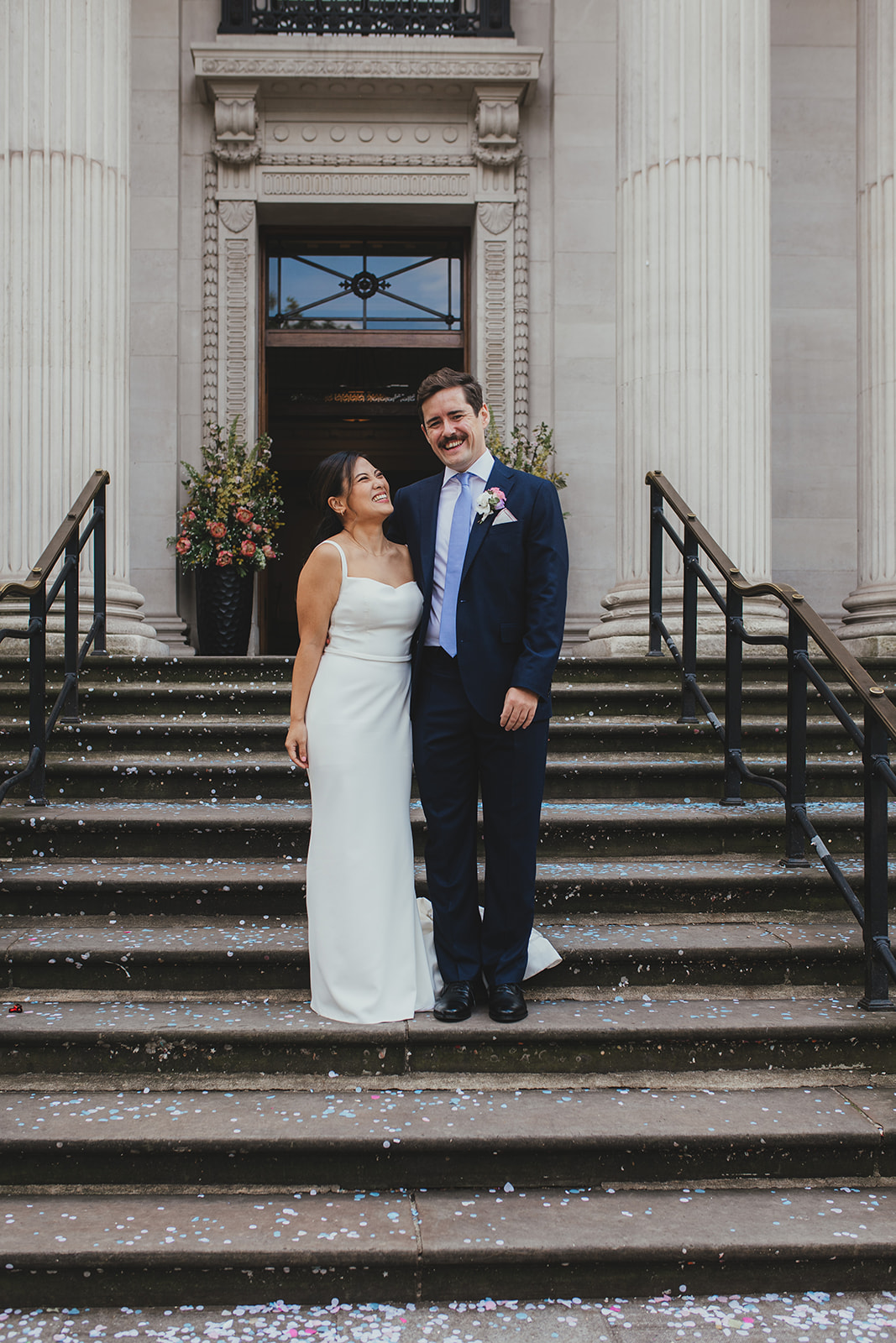 Bride and groom portrait on the steps of Old Marylebone Town Hall