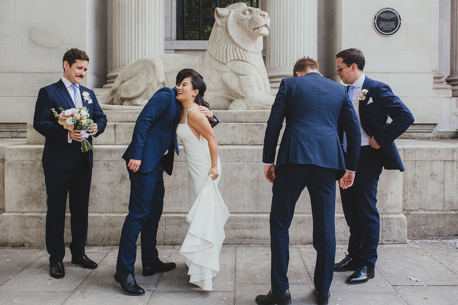 Bride greeting guests outside Old Marylebone Town Hal