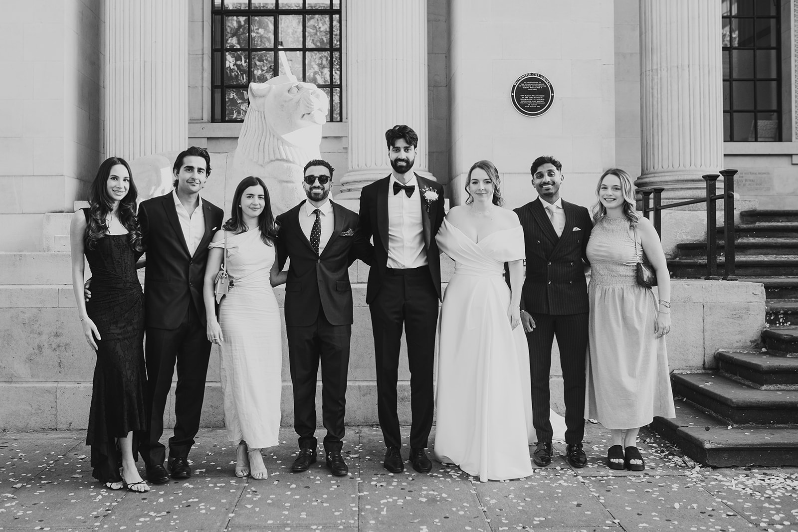 Group photo of wedding guests outside Old Marylebone Town Hall entrance, London