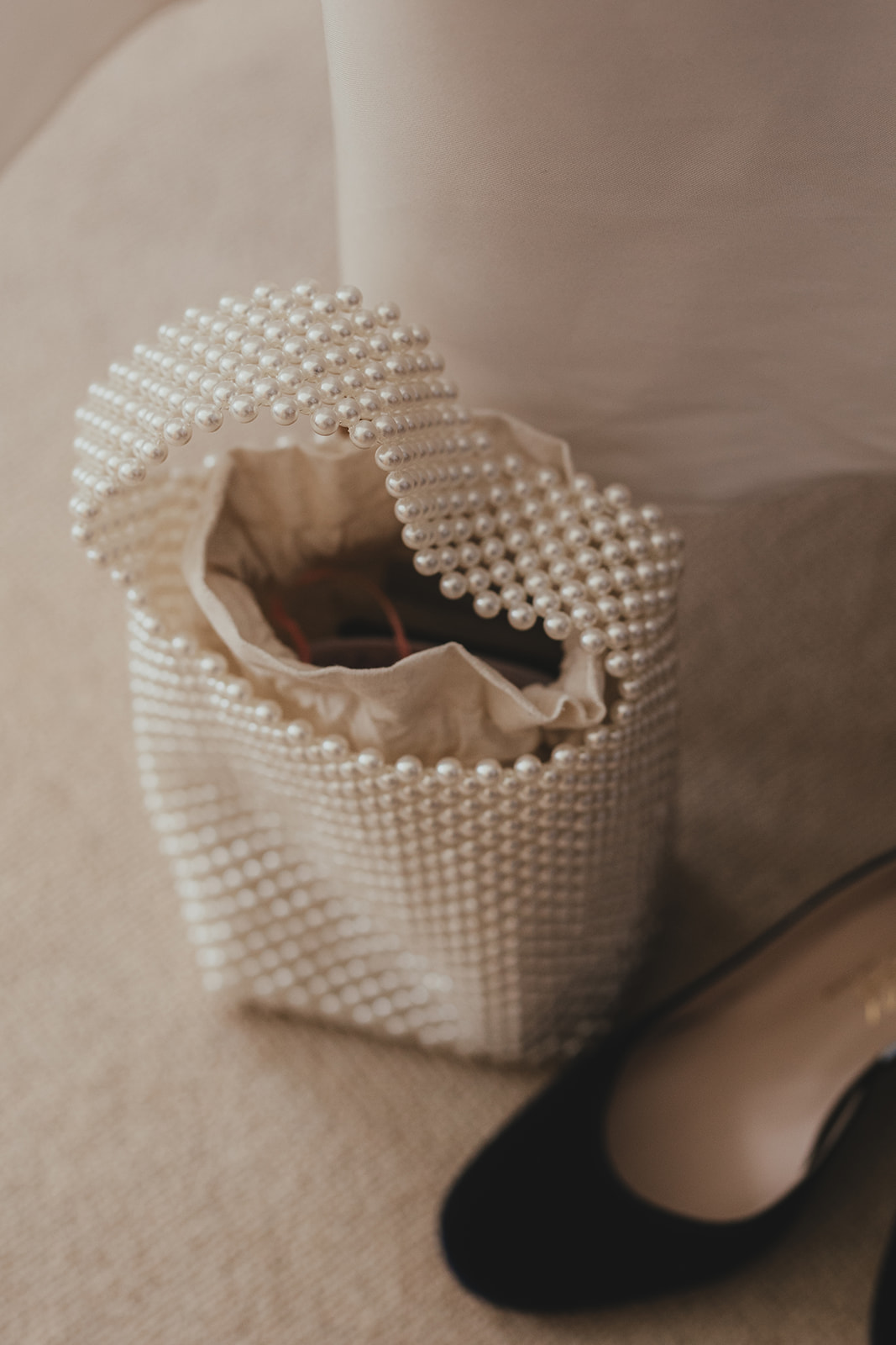 Close-up of a beaded pearl handbag detail.