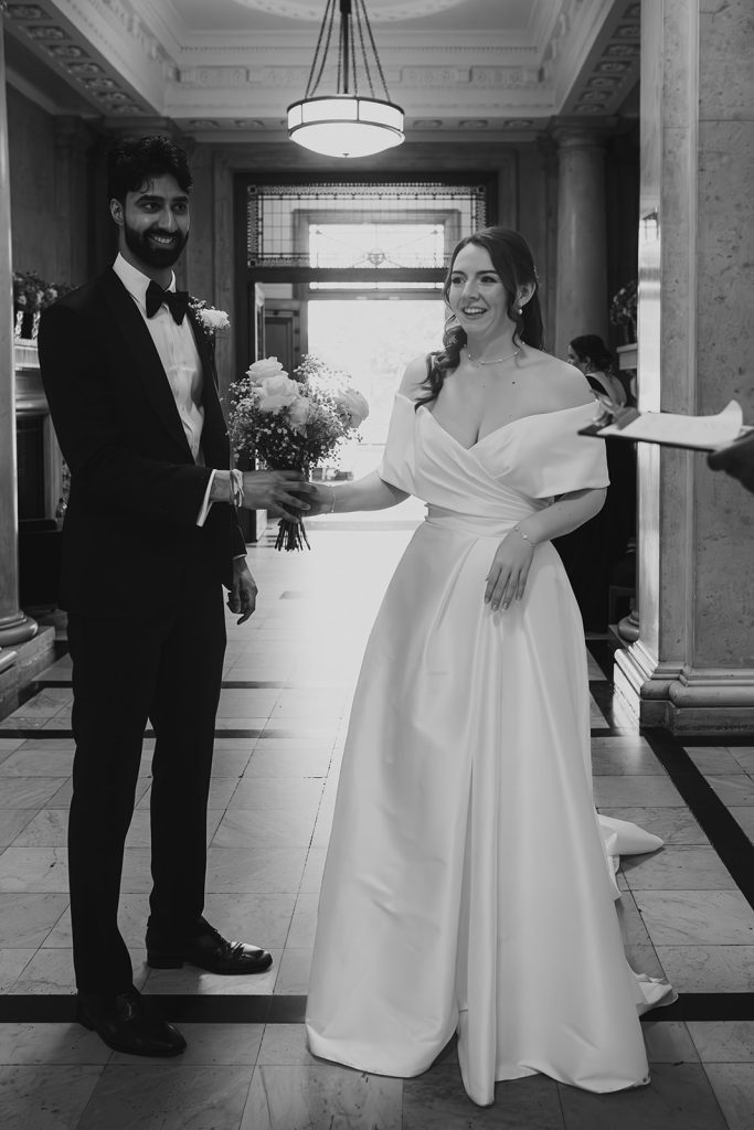 Black and white portrait of the bride and groom during their ceremony at Old Marylebone Town Hall
