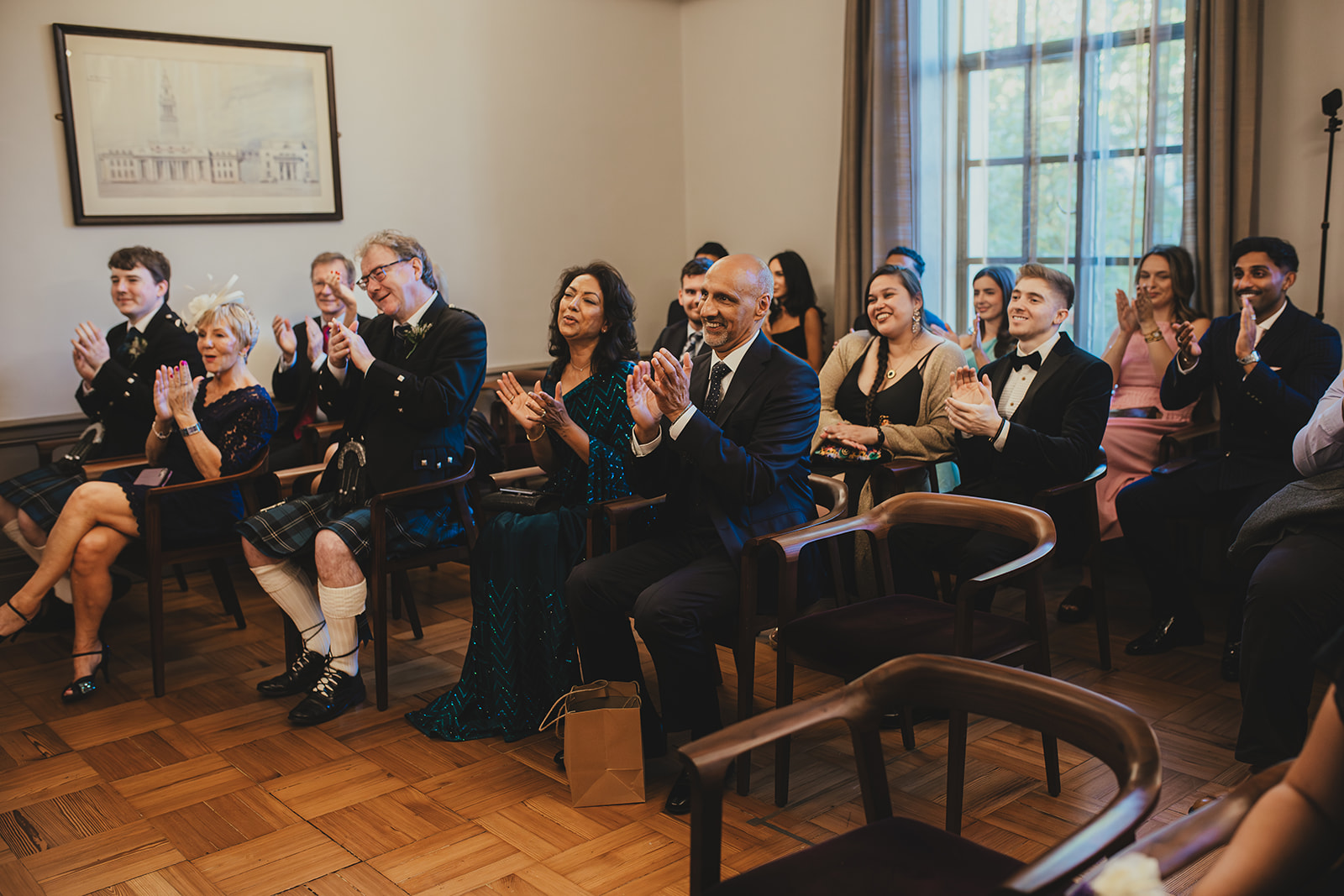 Guests applaud during the ceremony in the Mayfair Room at Old Marylebone Town Hall