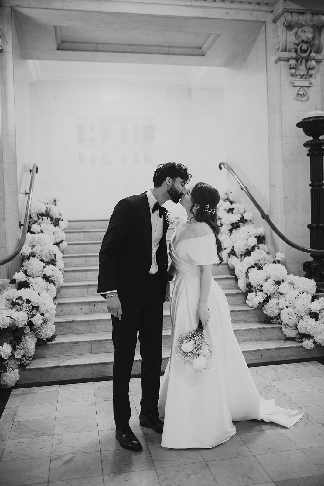 Black and white photo of the bride and groom laughing together inside Old Marylebone Town Hall