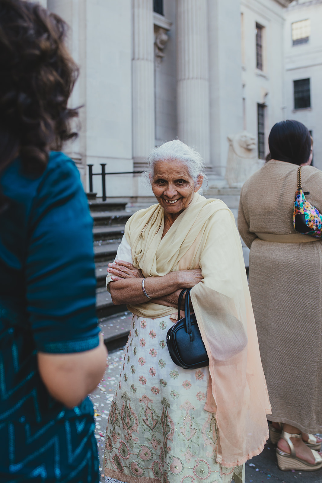 Portrait of an elderly wedding guest smiling outside Old Marylebone Town Hall, London