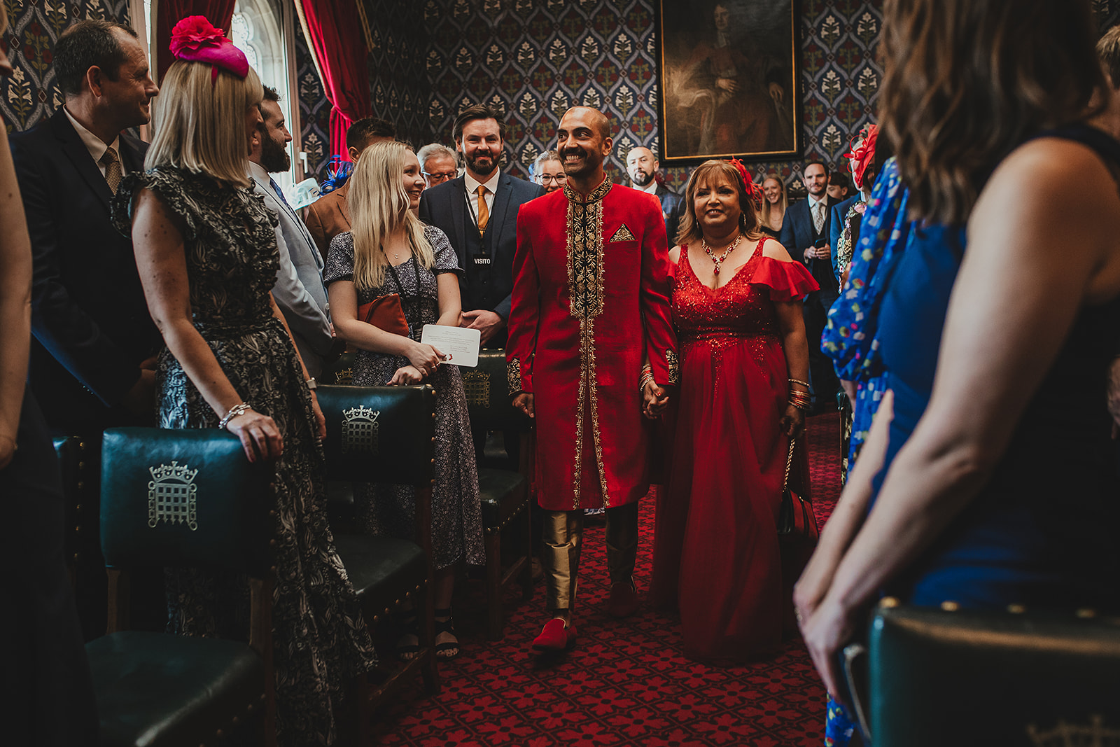 Groom waling down the aisle with mother at Palace of Westminster ceremony