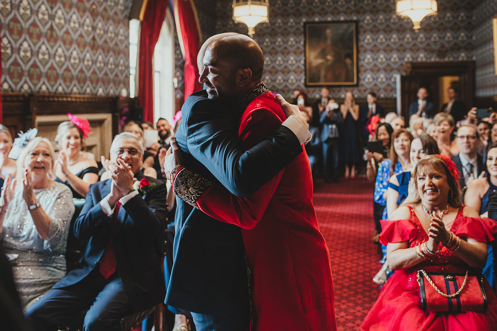 Grooms hugging after being married in the Palace of Westminster, London