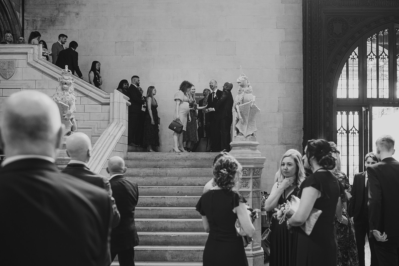 Guests congratulating  groom and groom after their ceremony in the Palace of Westminster