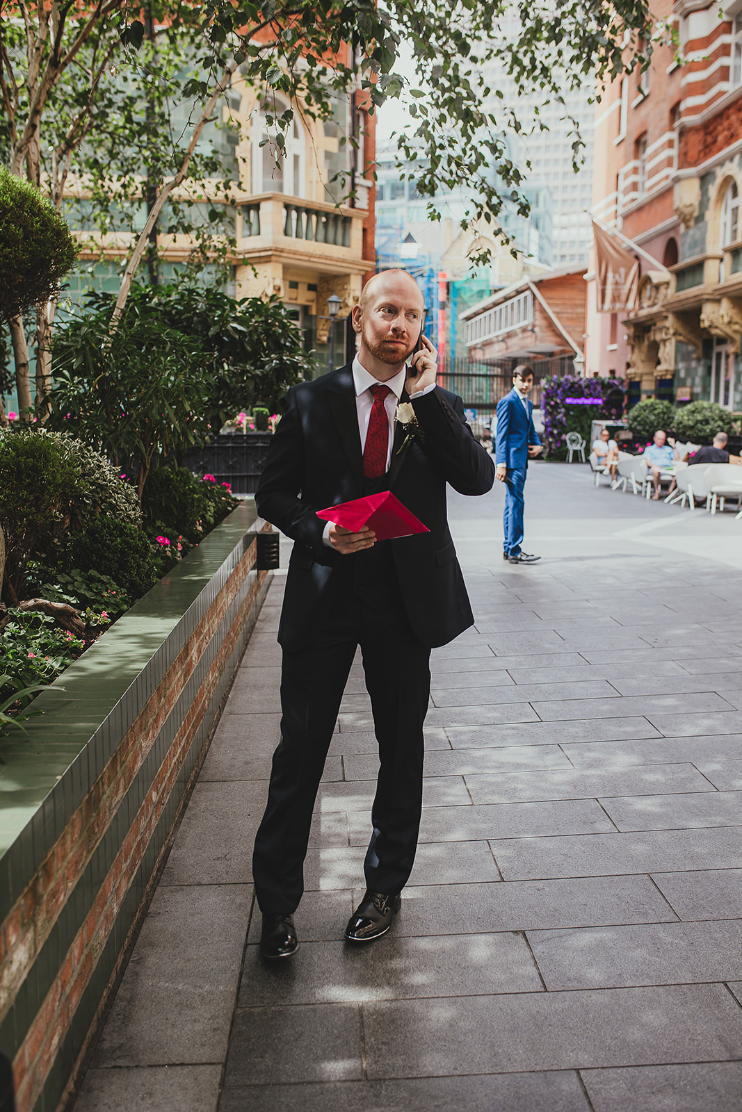 Groom waiting outside the Taj, London on the phone before the ceremony
