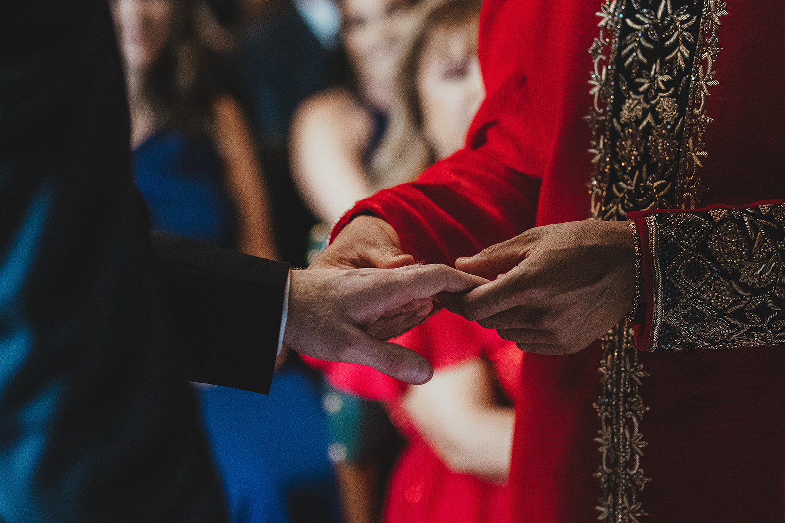 Grooms exchanging rings in their wedding ceremony at the Palace of Westminster