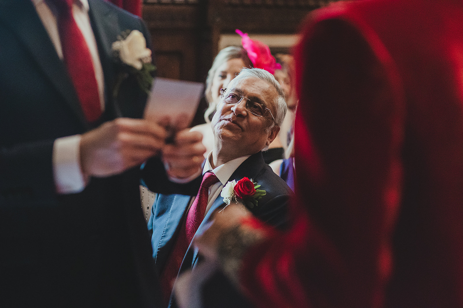 Guests watchin grooms marry at their ceremony in Palace of Westminster, London