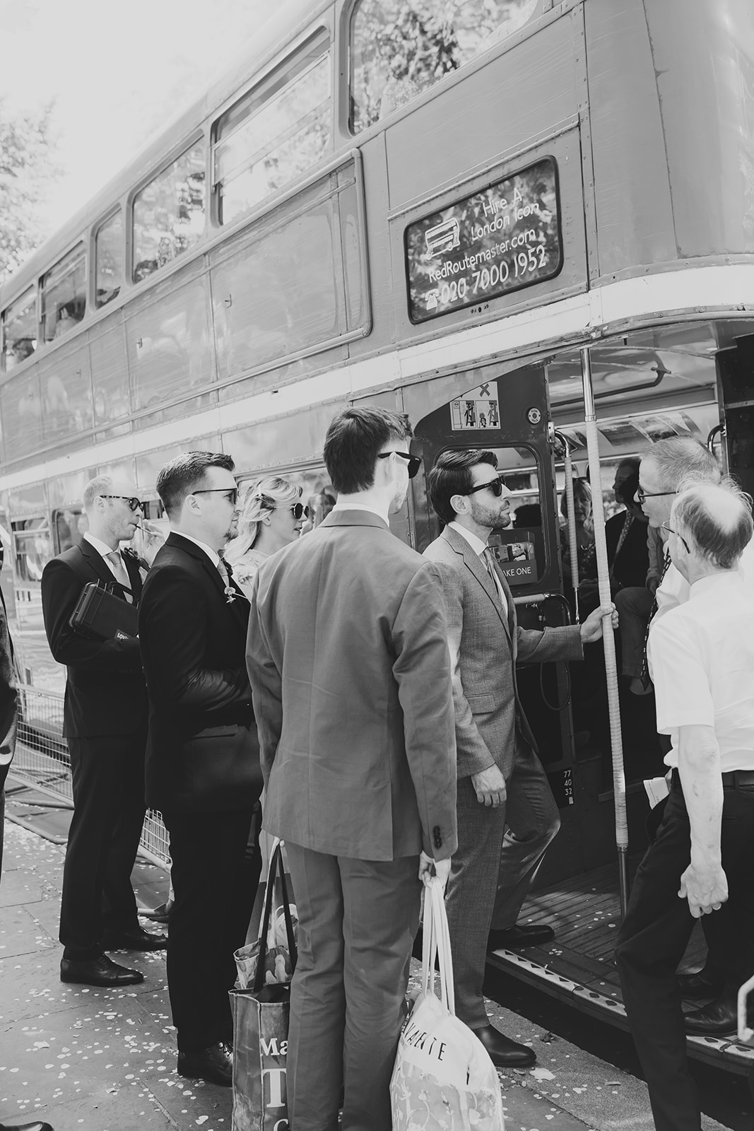Groom and guests getting on Route Master bus to go to the wedding reception at The Depot n7, London wedding