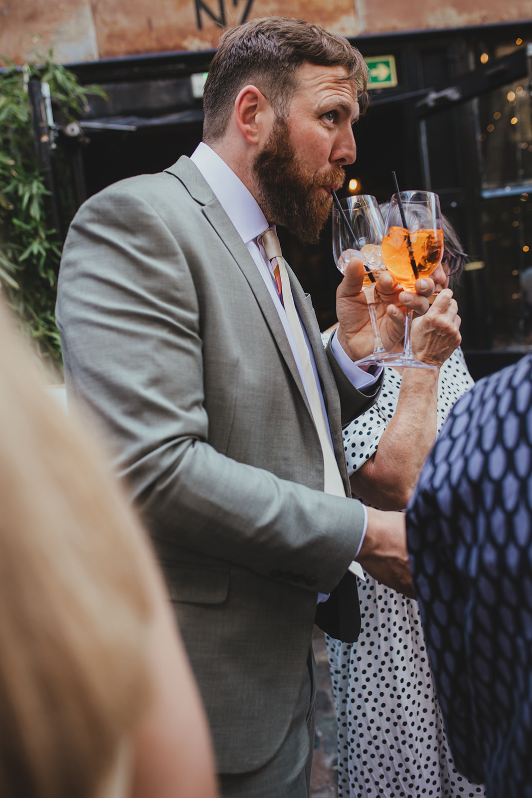 Wedding guest with drinks at The Depot N7 wedding reception, London wedding